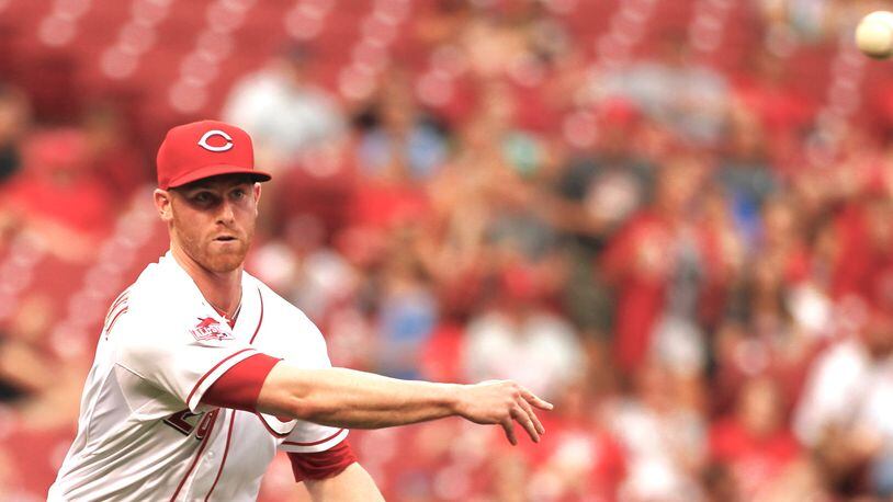Reds pitcher Anthony DeSclafani throws to first for an out against the Phillies on Tuesday, June 9, 2015, at Great American Ball Park in Cincinnati. David Jablonski/Staff