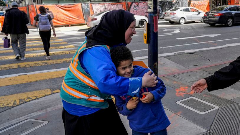 Tatiana Alabsi, left, hugs her nephew Adam Khalid as she roams the Tenderloin neighborhood Wednesday, March 20, 2024, in San Francisco. (AP Photo/Godofredo A. Vásquez)