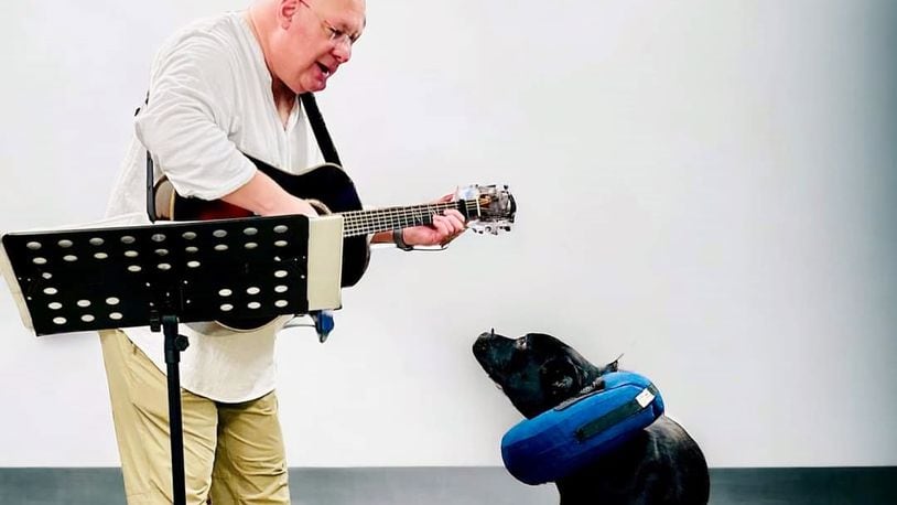 The photo is of Banjo, a resident of The Humane Society of Hobart, listening to Lee playing his guitar and singing. CONTRIBUTED
