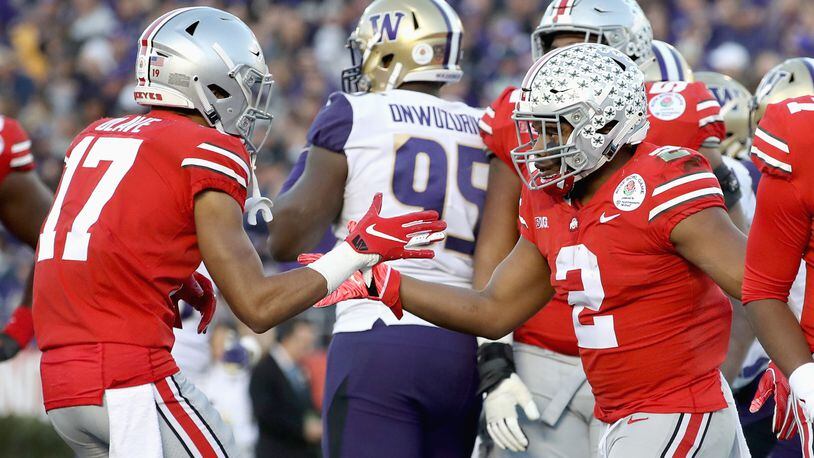 PASADENA, CA - JANUARY 01: Chris Olave #17 of the Ohio State Buckeyes and J.K. Dobbins #2 of the Ohio State Buckeyes celebrate after a touchdown during the second half in the Rose Bowl Game presented by Northwestern Mutual at the Rose Bowl on January 1, 2019 in Pasadena, California.  (Photo by Sean M. Haffey/Getty Images)