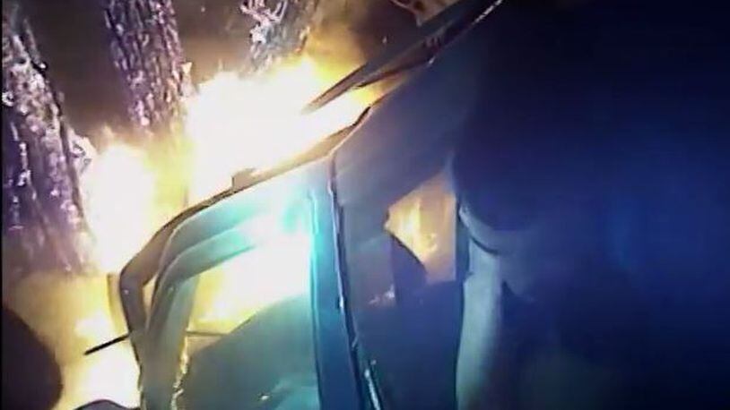 An Athens-Clarke County police officer saves a man from a car fire on Aug. 18. (Credit: YouTube)