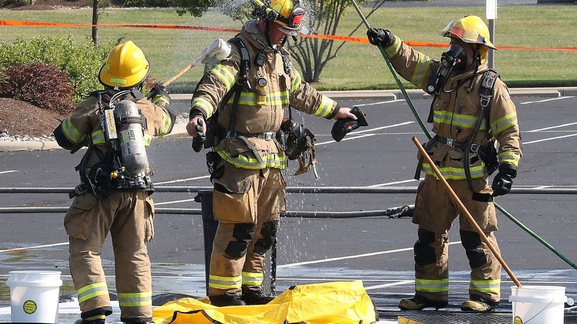 A firefighter is decontaminated in the parking lot of Springfield Regional Medical Center Friday. The Clark County Local Emergency Planning Committee hosted a training event Friday in the parking lot of Springfield Regional Medical Center. The training involved a simulated vehicle accident with a hazmat spill staged in one portion of the parking lot. BILL LACKEY/STAFF