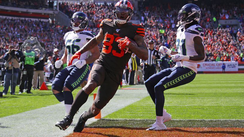 CLEVELAND, OHIO - OCTOBER 13: Ricky Seals-Jones #83 of the Cleveland Browns scores a second quarter touchdown next to Tre Flowers #21 of the Seattle Seahawks at FirstEnergy Stadium on October 13, 2019 in Cleveland, Ohio. (Photo by Gregory Shamus/Getty Images)