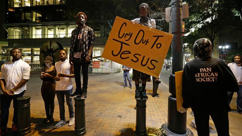 Demonstrators take to the streets of uptown during a peaceful march following Tuesday's police shooting of Keith Lamont Scott in Charlotte, N.C., Thursday, Sept. 22, 2016. (AP Photo/Gerry Broome)