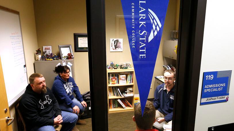 An admissions specialist at Clark State Community College, talks to the Watson family about Kage Watson, a high school senior, attending Clark State next year. Bill Lackey/Staff