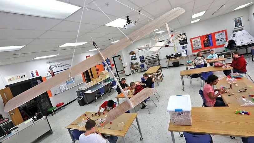 Balsa wood airplanes designed by a class at Graham Middle School twirl in the wind as the hang from the ceiling of the classroom Wednesday, May 2, 2018. Bill Lackey/Staff