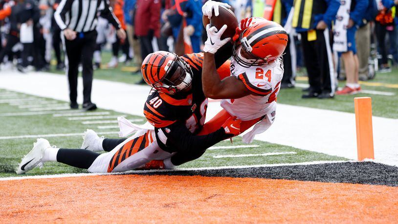 CINCINNATI, OH - NOVEMBER 25: Nick Chubb #24 of the Cleveland Browns catches a pass for a touchdown over the defense of Brandon Wilson #40 of the Cincinnati Bengals during the second quarter at Paul Brown Stadium on November 25, 2018 in Cincinnati, Ohio. (Photo by Joe Robbins/Getty Images)
