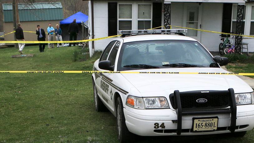 Authorities surrounded the yard of a home in the 5400 block of Highland Road with yellow police tape after the body of 5-year-old Noah Terry Thomas was found in a septic tank in in Pulaski County Va. Thursday March 26 2015. (AP Photo / The Roanoke Times, Matt Gentry)