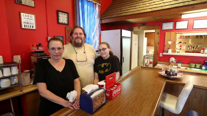 Mandie Warner, owner of Sis’s Restaurant in Catawba, and employees Paul Koenig and Lexi Herron behind the counter at the restaurant. BILL LACKEY/STAFF