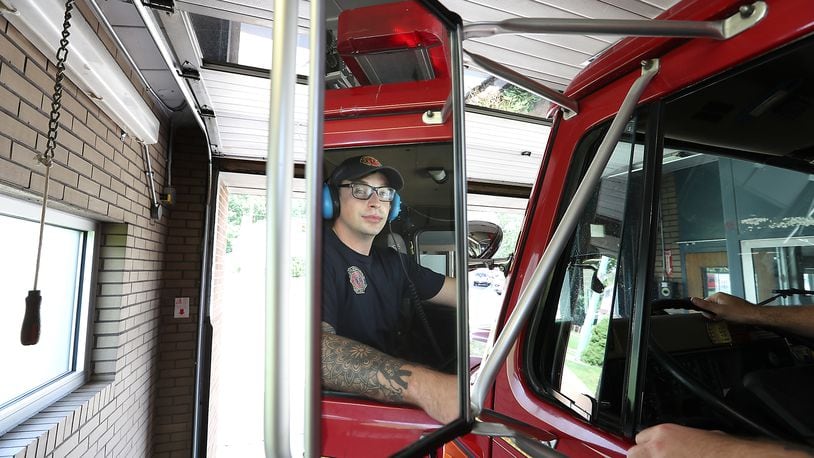 Springfield fire fighter Skyler Baise checks his mirrors as he backs the fire engine into the tiny garage bay at Fire Station #3. That station could be replaced as the city looks to build three new fire stations. BILL LACKEY/STAFF