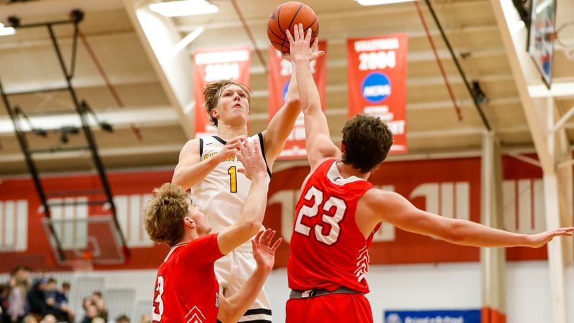 Shawnee junior Connar Earles shoots the ball over Southeastern seniors Ayden Robinson (23) and Zach McKee during their game on Friday afternoon at Wittenberg University’s Pam Evans Smith Arena. Michael Cooper/CONTRIBUTED