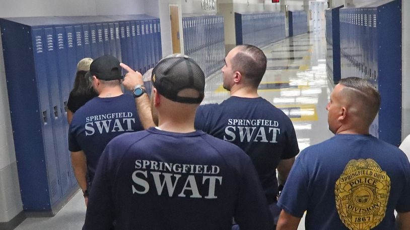 Members of the Springfield Police Division's SWAT team conduct a safety walk-through of Springfield High School Tuesday, August 9, 2022. BILL LACKEY/STAFF