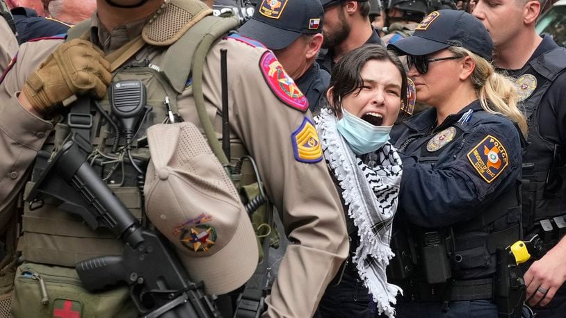 A woman is arrested at a pro-Palestinian protest at the University of Texas, Wednesday, April 24, 2024, in Austin. (Austin American-Statesman via AP)