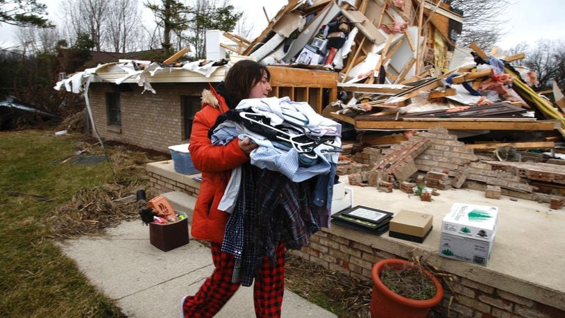 Rebekah Stewart sorts through what’s left of her families house for clothes and personal belongings Wednesday afternoon. Wednesday’s storm destroyed Rebekah’s home and severely damaged several others on Mitchell Road. BILL LACKEY/STAFF