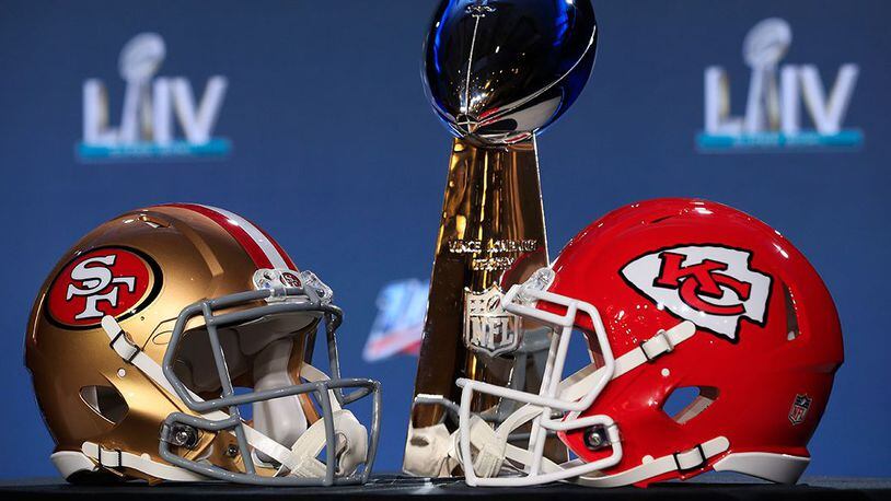 The Vince Lombardi Trophy is displayed with helmets of the San Francisco 49ers and Kansas City Chiefs. (Cliff Hawkins/Getty Images)