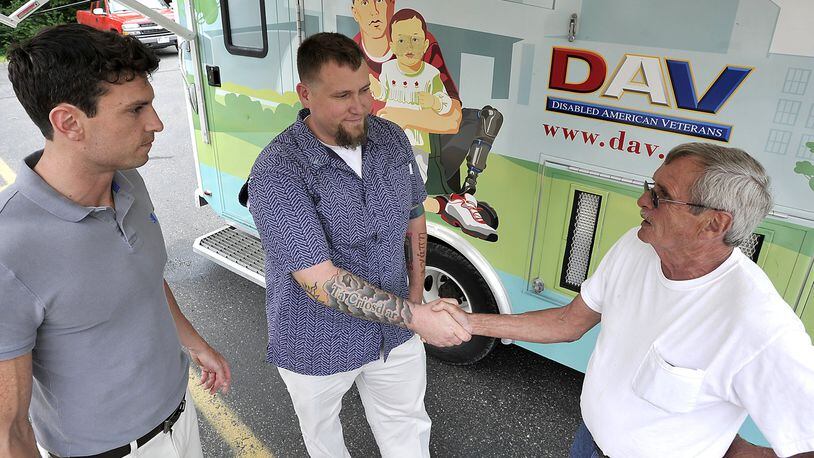 Veteran Mick Sullivan, right, meets with Josh Rondini, left, and Matt Persons outside the Disabled American Veterans’ Mobile Service Office on Monday, June 24, 2013, during the mobile office’s stop at the Clark County DAV on Mechanicsburg Road. Bill Lackey/Staff