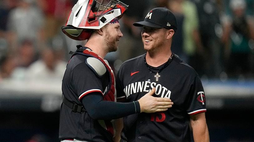 Minnesota Twins catcher Ryan Jeffers, left, and pitcher Emilio Pagán celebrate after the Twins defeated the Cleveland Guardians in a baseball game, Tuesday, Sept. 5, 2023, in Cleveland. (AP Photo/Sue Ogrocki)