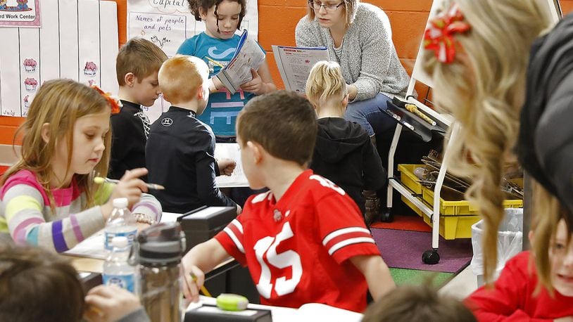 Emily Jurich works with first grade students at West Liberty-Salem School Thursday. Bill Lackey/Staff