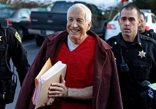 Former Penn State University assistant football coach Jerry Sandusky, center, arrives at the Centre County Courthouse for a post-sentence motion.