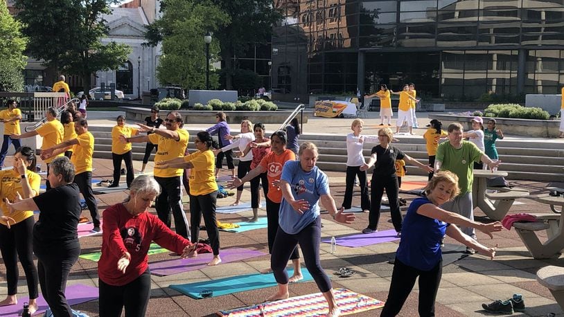 Participants practiced various yoga moves under sunny skies at International Yoga Day, presented by the Hindu Community of Springfield and the Global Education and Peace Network. Photo by Brett Turner