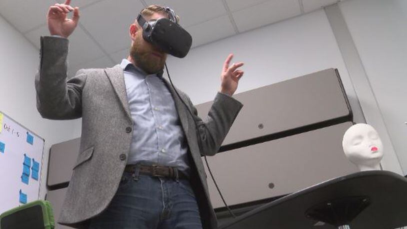 Vince Kilian, Marxent product development lead, uses a virtual reality headset. Virtual and augmented reality are being integrated into the shopping experience at many retailers, such as Macy's.