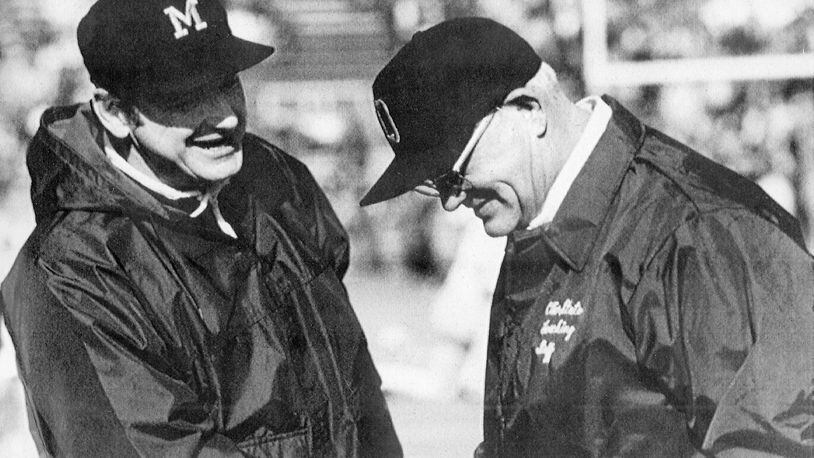 Michigan football coach Bo Schembechler, left, meets with Ohio State coach Woody Hayes in this undated file photo, location unknown. The 10 games featuring Hayes and Schembechler are remembered as the highlight of the series. The Buckeyes or Wolverines were in the Rose Bowl each year the two legendary coaches dueled for a win in one of college football’s greatest rivalries from 1969-78. (AP Photo)