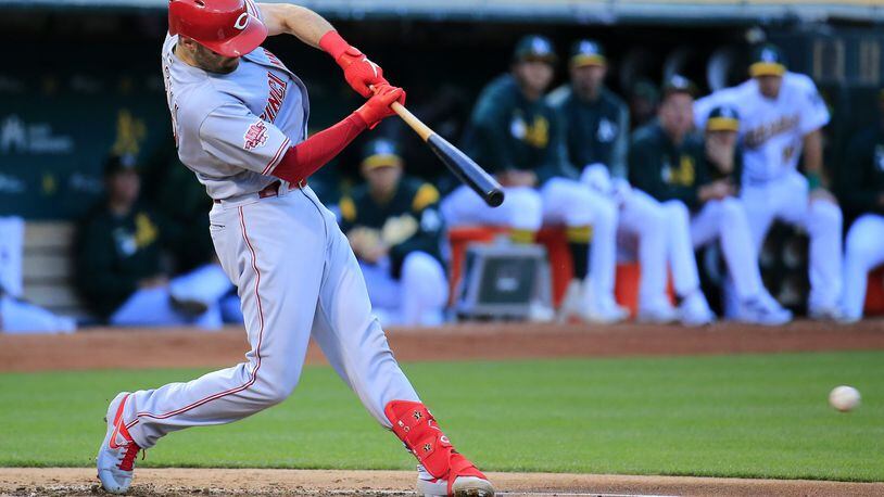 OAKLAND, CALIFORNIA - MAY 08: Curt Casali #12 of the Cincinnati Reds hits an RBI single during the second inning against the Oakland Athletics at Oakland-Alameda County Coliseum on May 08, 2019 in Oakland, California. (Photo by Daniel Shirey/Getty Images)