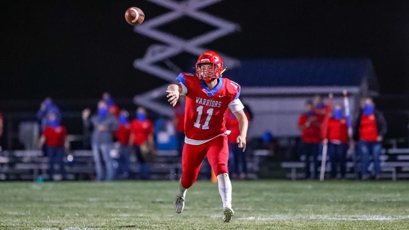 Action cutline: Northwestern High School quarterback Brock Mansfield throws the ball during their game against Indian Lake last season at Taylor Field in Springfield. CONTRIBUTED PHOTO BY MICHAEL COOPER