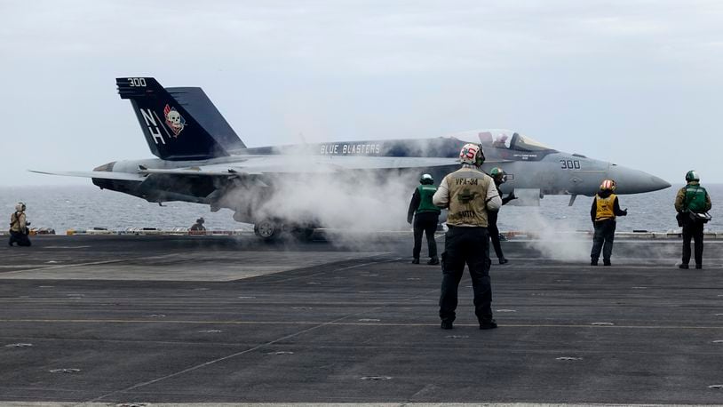 A F-18E fighter jet prepares to take off from USS Theodore Roosevelt aircraft carrier on Thursday April 11, 2024, during a three-day joint naval exercise by the U.S., Japanese and South Korea at the East China Sea amid tension from China and North Korea. (AP Photo/Mari Yamaguchi)