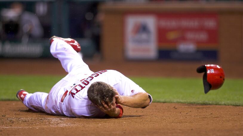 St. Louis Cardinals right fielder Stephen Piscotty gets hit by a throw in the bottom of the fifth inning during a Tuesday;'s baseball game between the St. Louis Cardinals and the Chicago Cubs.