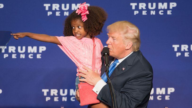 Republican presidential nominee Donald Trump holds a child as he speaks during a rally at the KI Convention Center on October 17, 2016 in Green Bay, Wisconsin. / AFP / Tasos Katopodis (TASOS KATOPODIS/AFP/Getty Images)