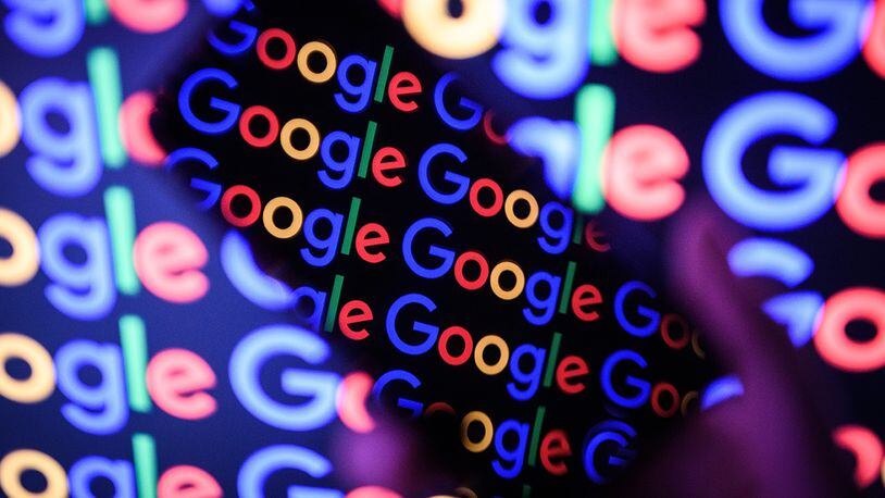 In this photo illustration,  The Google logo is displayed on a mobile phone and computer monitor. Google released its annual round up of search trends.