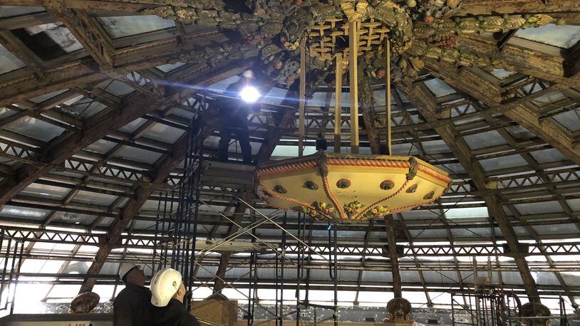 Dave Williams, senior development director with Cross Street Partners, examines the metal cornucopia in the center of the metal Dayton Arcade dome. The metal structure will be repainted, as will the 16 plaster turkeys around the dome. CORNELIUS FROLIK / STAFF