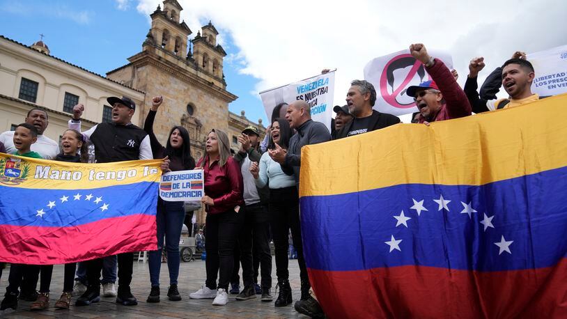 FILE - Venezuelans, who support opposition leader María Corina Machado, sing their native country's national anthem during a protest demanding free and fair elections in Venezuela's upcoming election, in Bolivar Square in Bogota, Colombia, April 6, 2024. Of the millions of Venezuelans who have fanned out around the world, including those who migrated before the economic crisis, only about 107,000 are registered to vote outside the South American country. (AP Photo/Fernando Vergara, File)