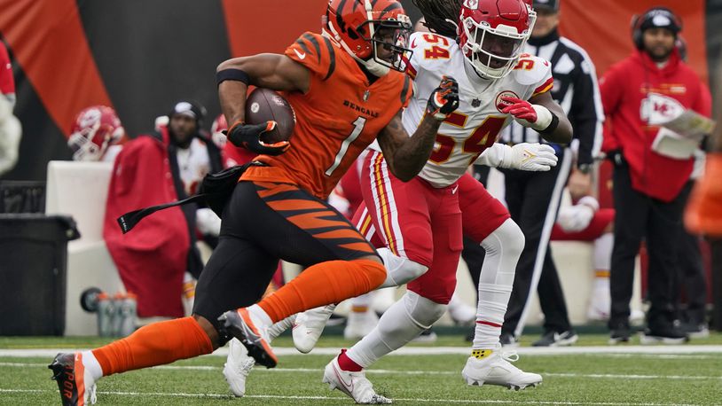 Cincinnati Bengals wide receiver Ja'Marr Chase (1) avoids Kansas City Chiefs outside linebacker Nick Bolton (54) for a 72-yard touchdown during the first half of an NFL football game, Sunday, Jan. 2, 2022, in Cincinnati. (AP Photo/Jeff Dean)