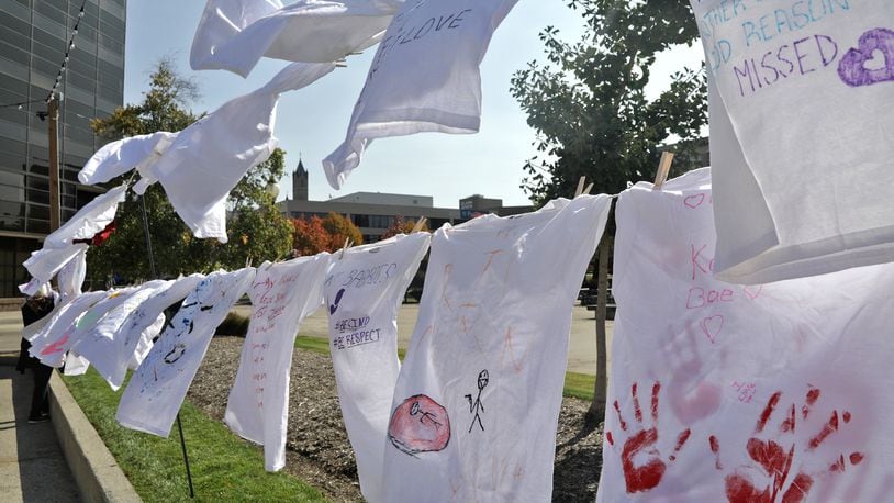 Clotheslines full of T-shirts with messages on them hang on the Springfield City Hall Plaza Friday, Oct. 14, 2022. The T-shirts are part of the Clothesline Project, which allows victims of violent crime to express their feelings in an anonymous way by writing or drawing on the T-shirts. This year's project is starting with 160 T-shirts but people are welcome to come down Friday till 7pm and Saturday from 9am till 7pm and create their own T-shirt message. BILL LACKEY/STAFF