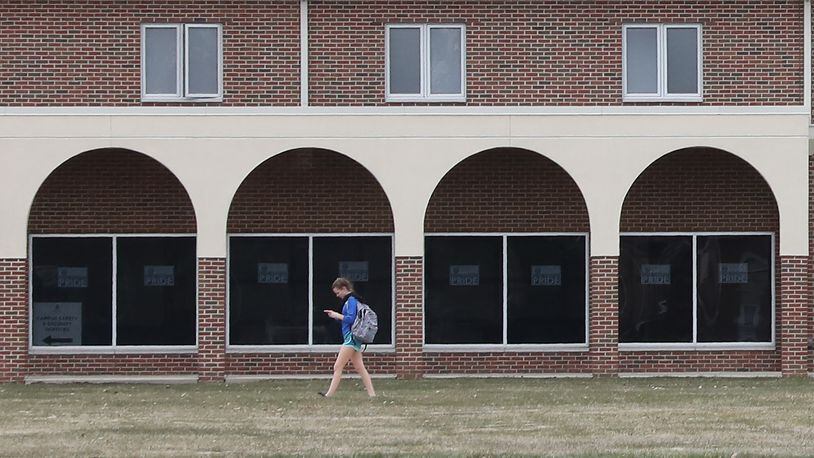 A student at Urbana University walks past the arches on one of the residence hall as she makes her way across campus in 2018. Bill Lackey/Staff