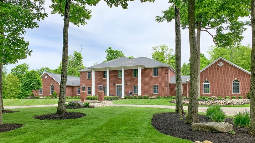 Offering 6 bedrooms, this brick home with a walk-out lower level and about 9,110 sq. ft. of living space is surrounded by 30 acres. The property includes a pool, 8-car attached garage and 4-car detached garage. CONTRIBUTED PHOTO