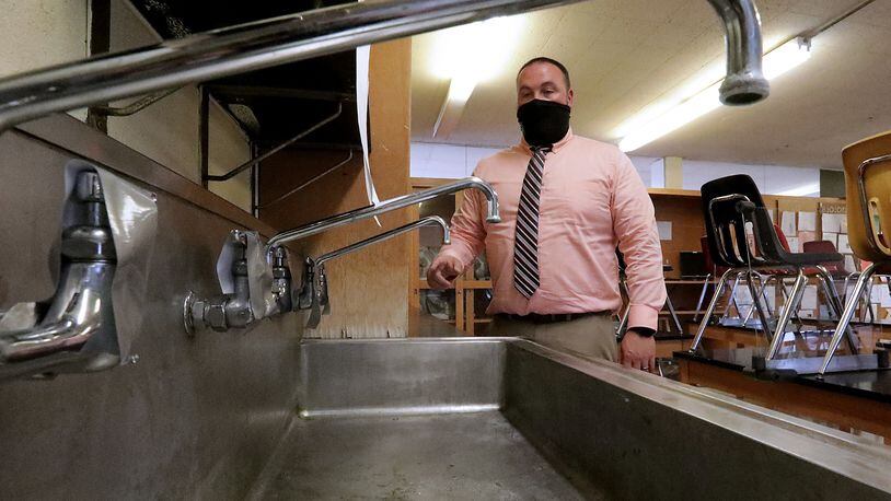 Jared Shore, principal at Greenon Junior/Senior High School, talks about how they've taken the faucets in one of the school's science labs out of service after traces of lead were found in the water. BILL LACKEY/STAFF