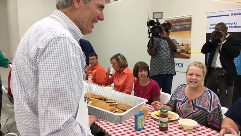 Sen. Rob Portman served pancakes to employees of Trimble in Huber Heights Monday morning. Afterwards, he visited with patients and counselors at a Dayton rehabilitation center. THOMAS GNAU/STAFF