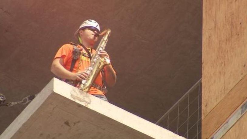 A construction worker is playing the saxophone to raise awareness and save a music venue. (Photo: KIRO7.com)