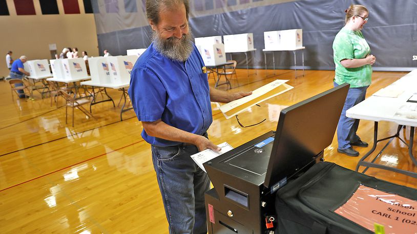Roger Phipps votes at Tecumseh High School Tuesday, August 8, 2023. BILL LACKEY/STAFF