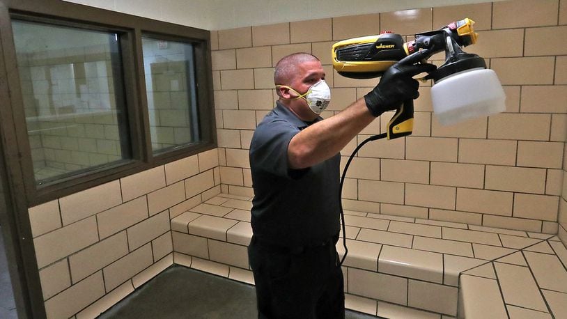 Deputy Shaun Lisle cleans a sanitizes a holding cell at the Clark County Jail Friday. BILL LACKEY/STAFF