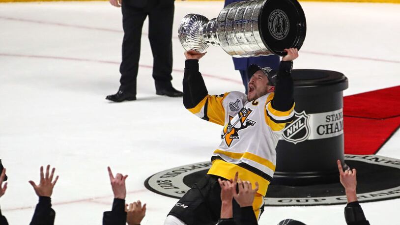 NASHVILLE, TN - JUNE 11:  Sidney Crosby #87 of the Pittsburgh Penguins celebrates with the Stanley Cup trophy after defeating the Nashville Predators 2-0 in Game Six of the 2017 NHL Stanley Cup Final at the Bridgestone Arena on June 11, 2017 in Nashville, Tennessee.  (Photo by Frederick Breedon/Getty Images)