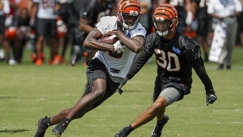 Cincinnati Bengals wide receiver A.J. Green, left, runs a play during NFL football practice, Friday, July 27, 2018, in Cincinnati. (AP Photo/John Minchillo)