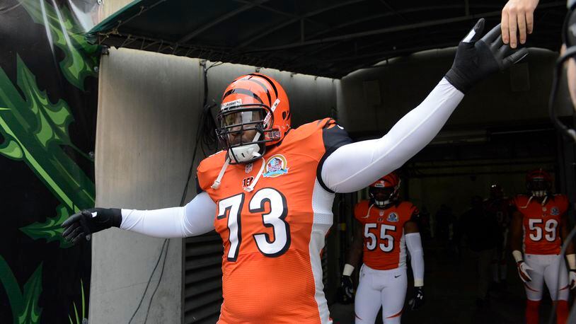 Cincinnati Bengals tackle Anthony Collins (73) runs onto the field at the start of an NFL football game against the Dallas Cowboys, Sunday, Dec. 9, 2012, in Cincinnati. (AP Photo/Michael Keating)