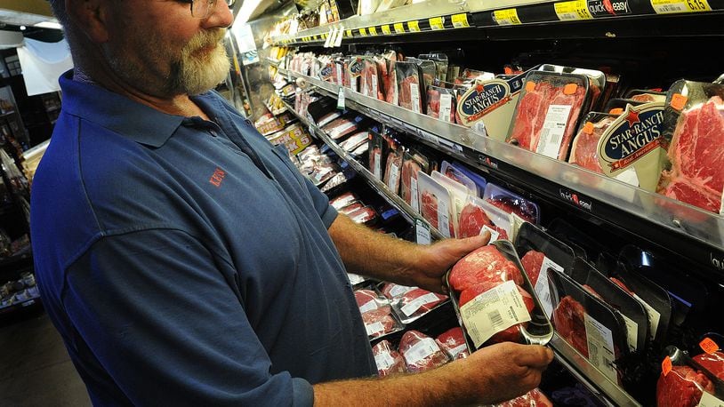 Ken Smith, selects steaks Thursday, June 30, 2022 for the upcoming holiday at the Grocerylan in Xenia. Lewis said, that the steaks from the store melt in your mouth. MARSHALL GORBY\STAFF