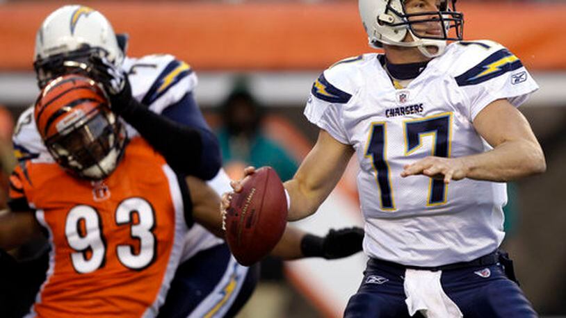San Diego Chargers quarterback Philip Rivers (17) passes against the Cincinnati Bengals in the first half of an NFL football game, Sunday, Dec. 26, 2010, in Cincinnati. Chargers offensive tackle Marcus McNeill (73) blocks Cincinnati Bengals linebacker Michael Johnson (93).