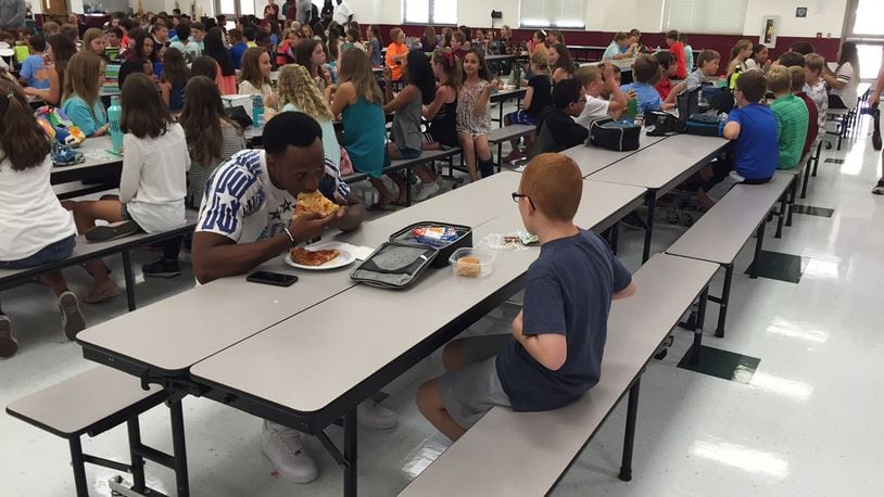 In this Tuesday, Aug, 30, 2016 photo provided by Michael Halligan, Florida State University wide receiver Travis Rudolph has lunch with Bo Paske at Montford Middle School in Tallahassee, Fla. A small gesture of kindness by Rudolph sent tears streaming down the face of the sixth-grader's mother, Leah Paske, who shared her gratitude on Facebook Tuesday afternoon after seeing a picture of Rudolph sharing lunch with her son Bo in his middle school cafeteria. (Michael Halligan via AP)