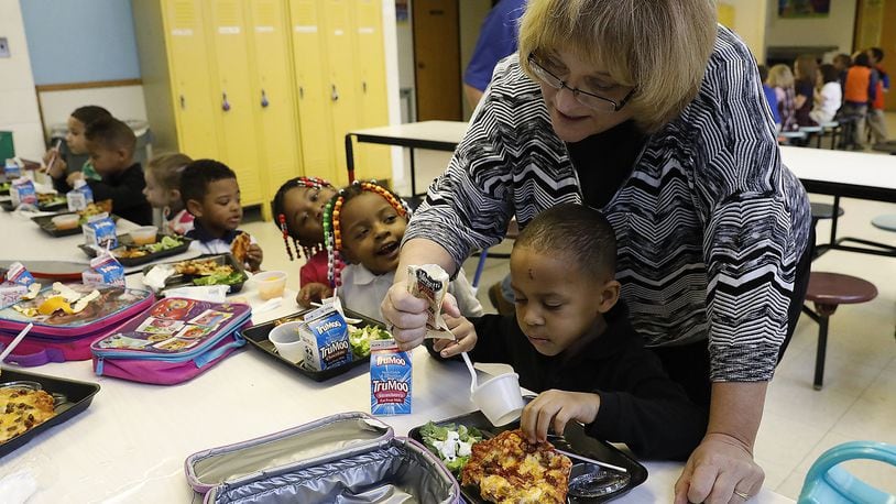 Donna Killin helps Jaden Couts and the other preschoolers at Springfield Christian School with their lunch Tuesday. Bill Lackey/Staff